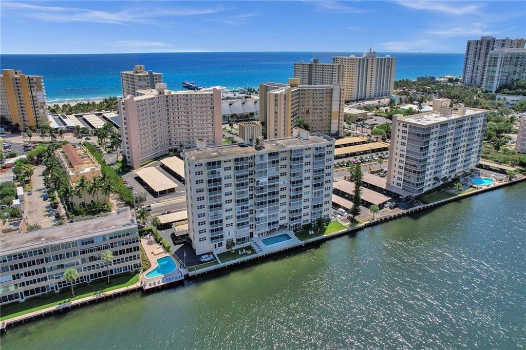 An aerial view of multiple waterfront apartment buildings with swimming pools along a canal — 303 N Riverside Drive # 4, Pompano Beach FL 33062, POMPANO BEACH, FL
