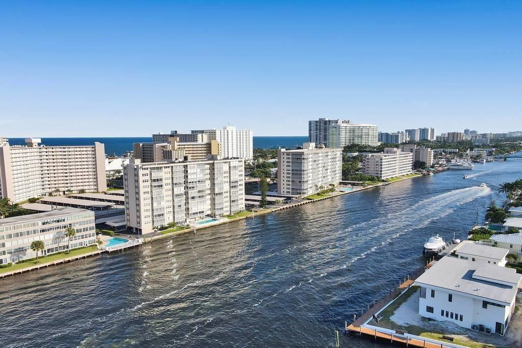 An aerial view of a waterway lined with apartment buildings and private docks — 303 N Riverside Drive # 4, Pompano Beach FL 33062, POMPANO BEACH, FL