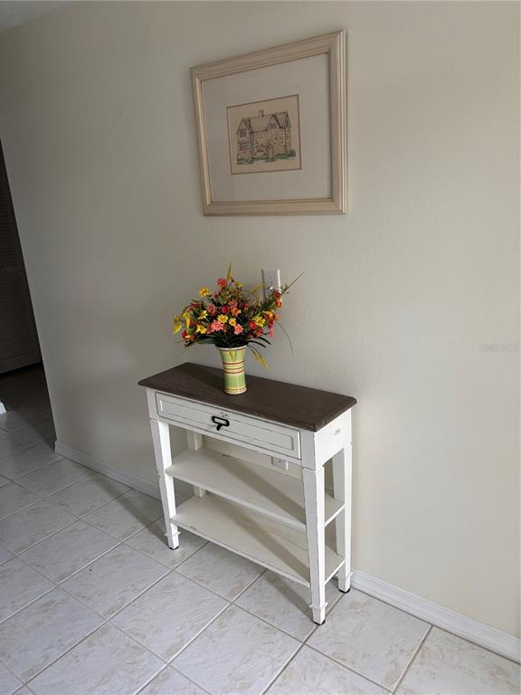 A white console table with a dark wood top sits against a beige wall — 6507 STONE RIVER ROAD UNIT 105, BRADENTON, FL