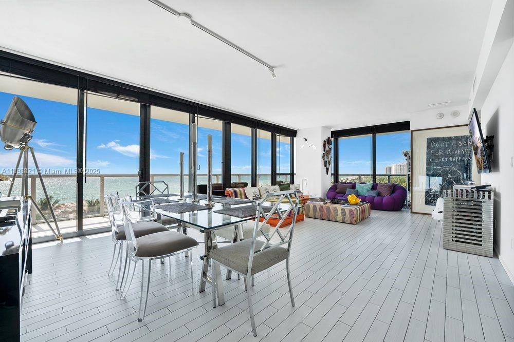 A bright living and dining area with floor-to-ceiling windows overlooking the ocean — 2201 Collins Ave # 628, Miami Beach FL 33139, MIAMI BEACH, FL