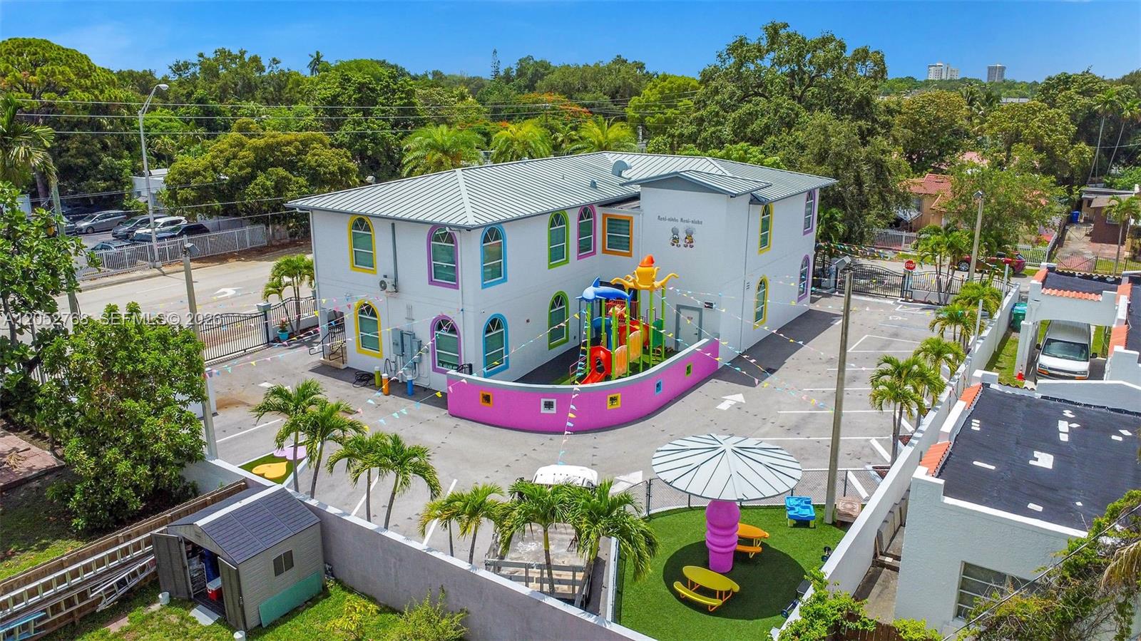 An aerial view shows a two-story daycare building with a colorful playground and parking lot — 2280 SW 17th Ave, Miami FL 33145, MIAMI, FL