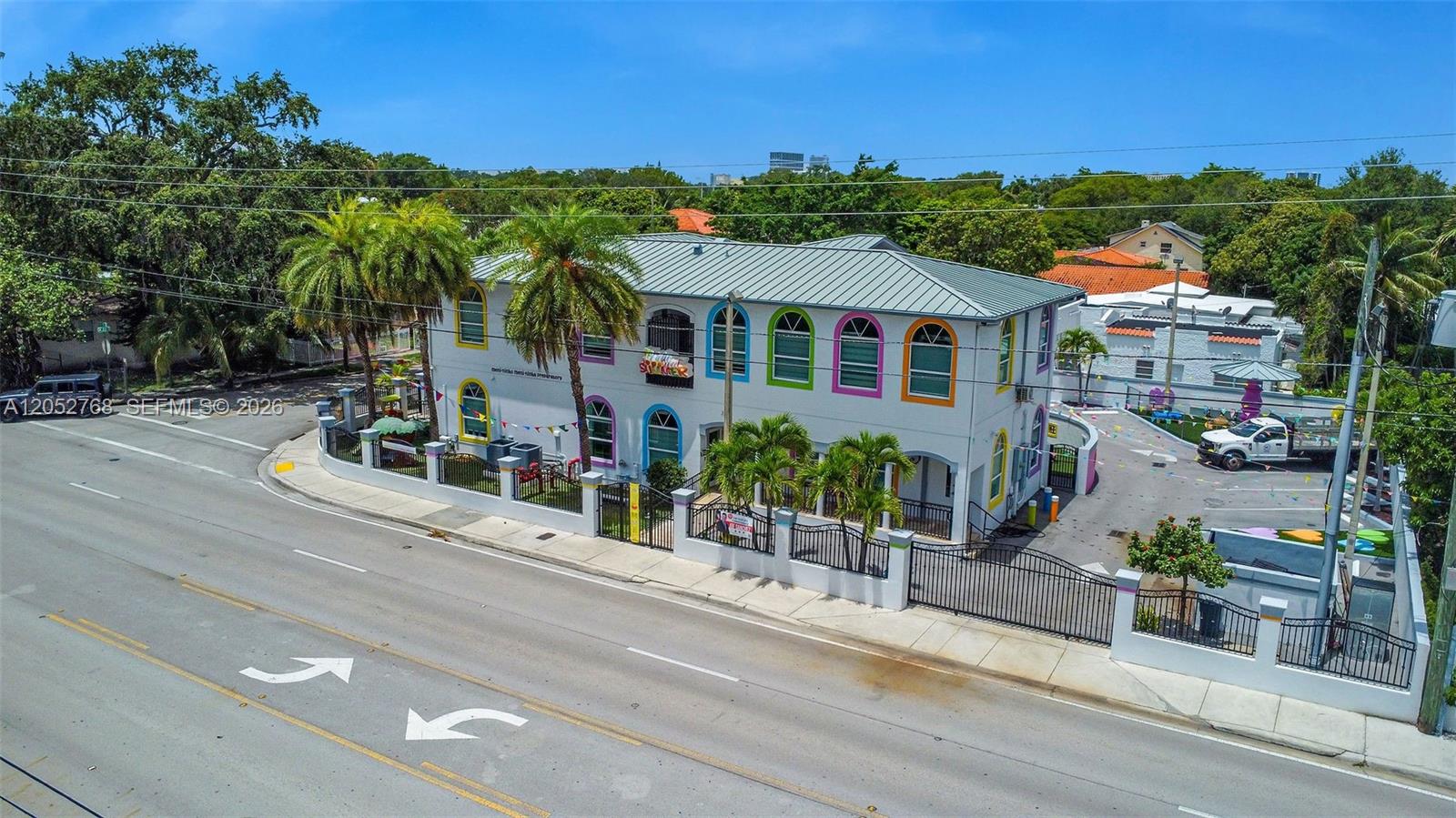 An aerial view of a two-story building with colorful window frames and a fenced yard — 2280 SW 17th Ave, Miami FL 33145, MIAMI, FL