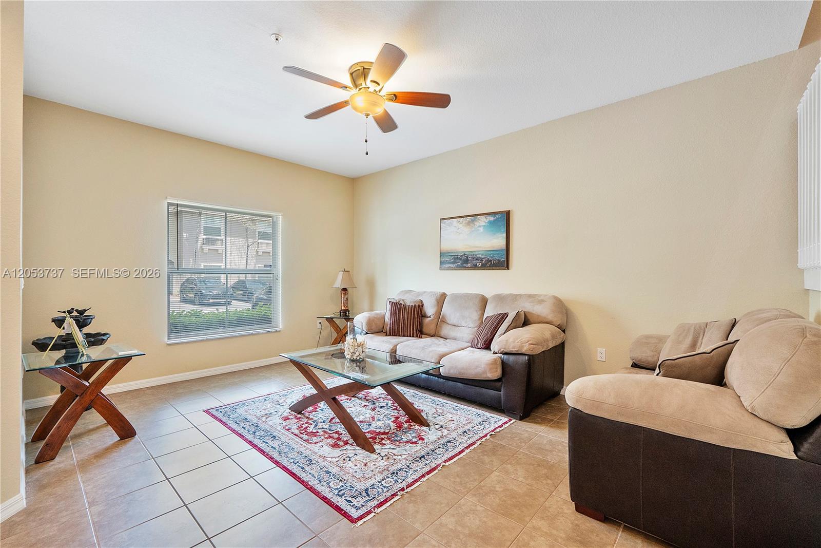 A living room features tile flooring, a ceiling fan, and two beige upholstered sofas — 2851 W Prospect Rd # 1307, Tamarac FL 33309, TAMARAC, FL