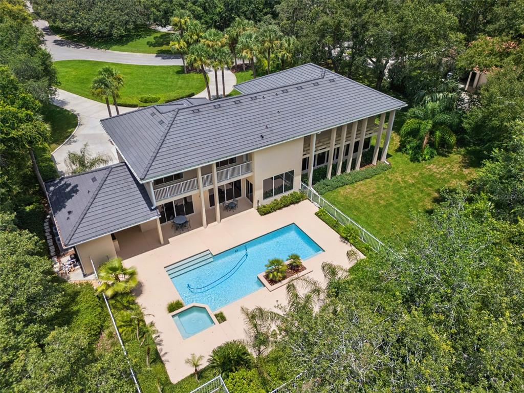 An aerial view of a two-story house with a swimming pool and a spa — 632 E CLUB CIRCLE, LONGWOOD, FL
