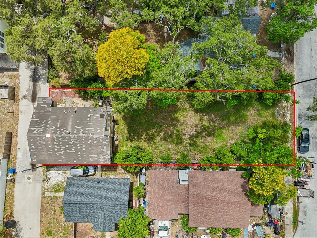 An aerial view shows a rectangular vacant lot bordered by a house and mature trees — 2210 20TH AVENUE S, ST PETERSBURG, FL