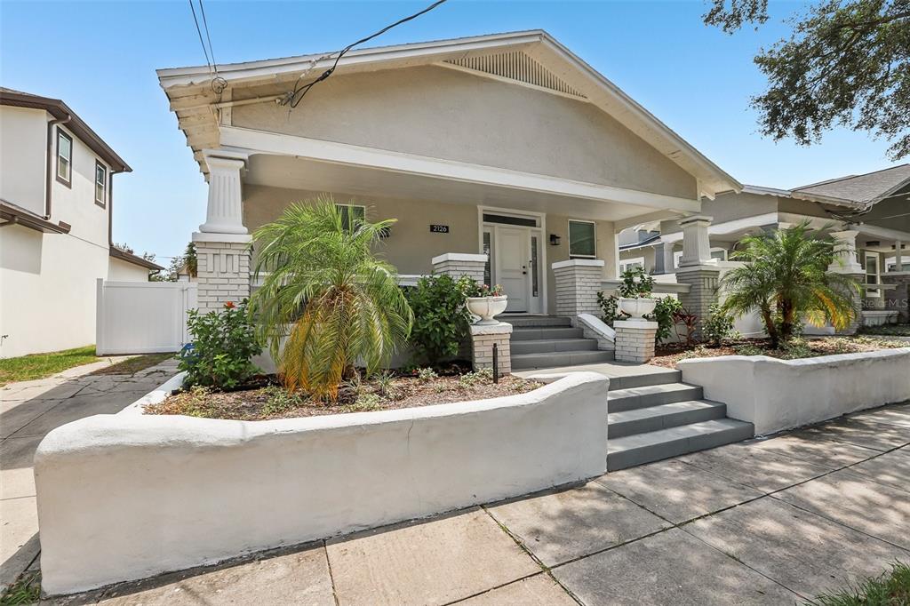 A single-story bungalow with a covered front porch, white brick pillars, and a concrete walkway — 2126 W BEACH STREET, TAMPA, FL