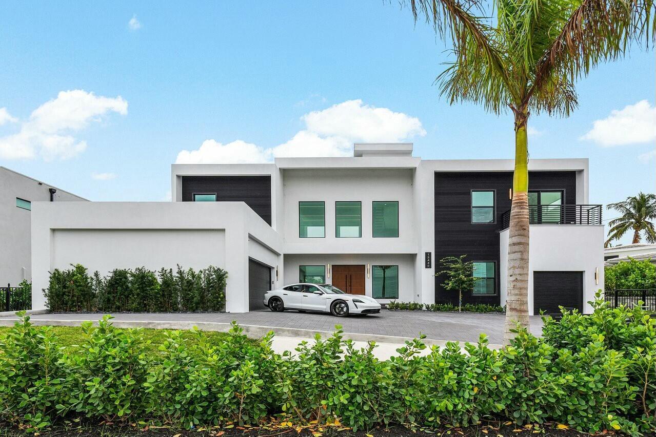 A modern two-story house with a white and black exterior and a white sports car — 13440 Us Highway 1, Juno Beach FL 33408, JUNO BEACH, FL
