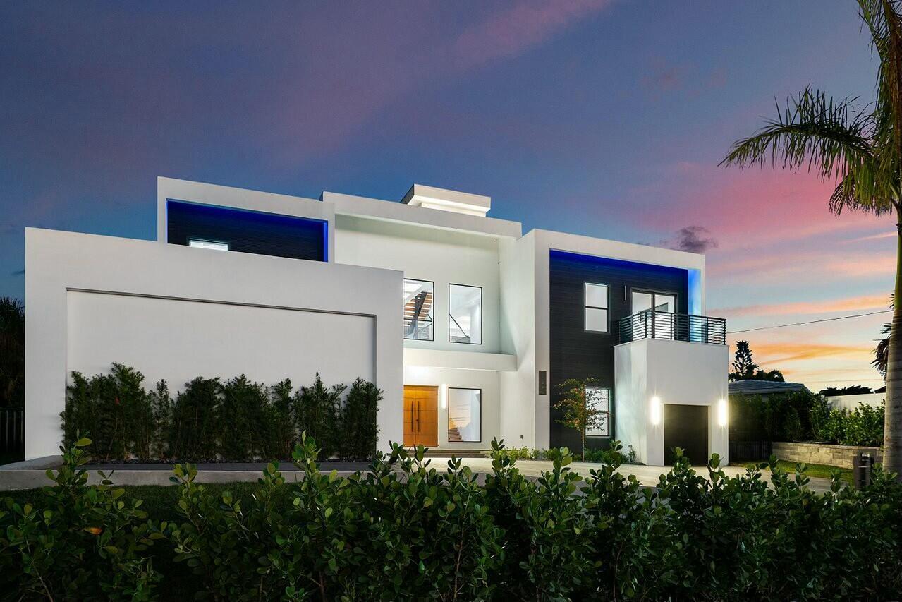 A modern two-story house with white and dark gray exterior walls at sunset — 13440 Us Highway 1, Juno Beach FL 33408, JUNO BEACH, FL