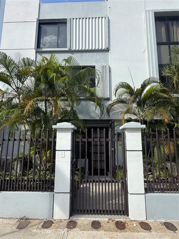 A white multi-story building features a gated entrance with two prominent concrete pillars — 1158 MAGDALENA UNIT 3, SAN JUAN, PR