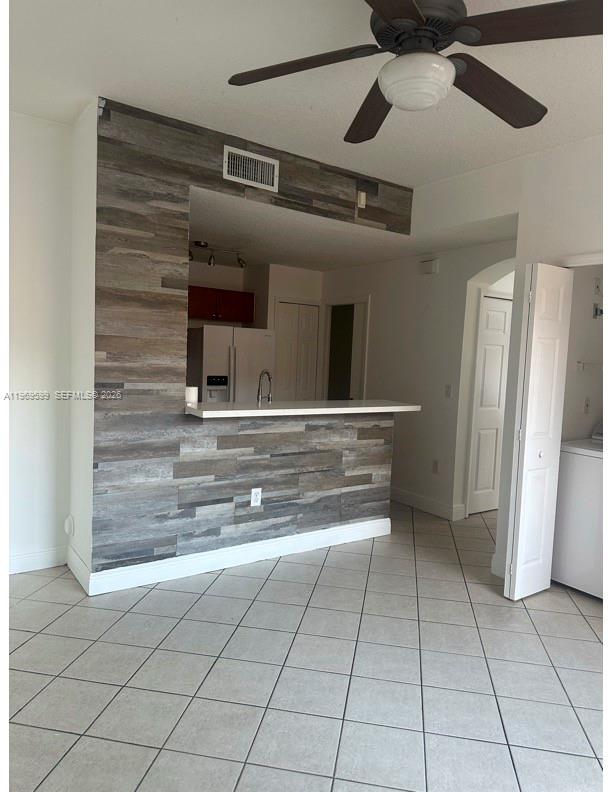 A kitchen with a wood-look tiled breakfast bar and white tile flooring — 11438 NW 62nd Ter # 226, Doral FL 33178, DORAL, FL
