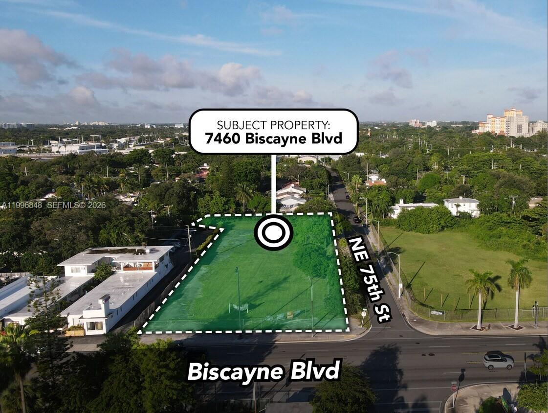 An aerial view shows a vacant, green-highlighted corner lot located at a street intersection — 7460 Biscayne Blvd, Miami FL 33138, MIAMI, FL