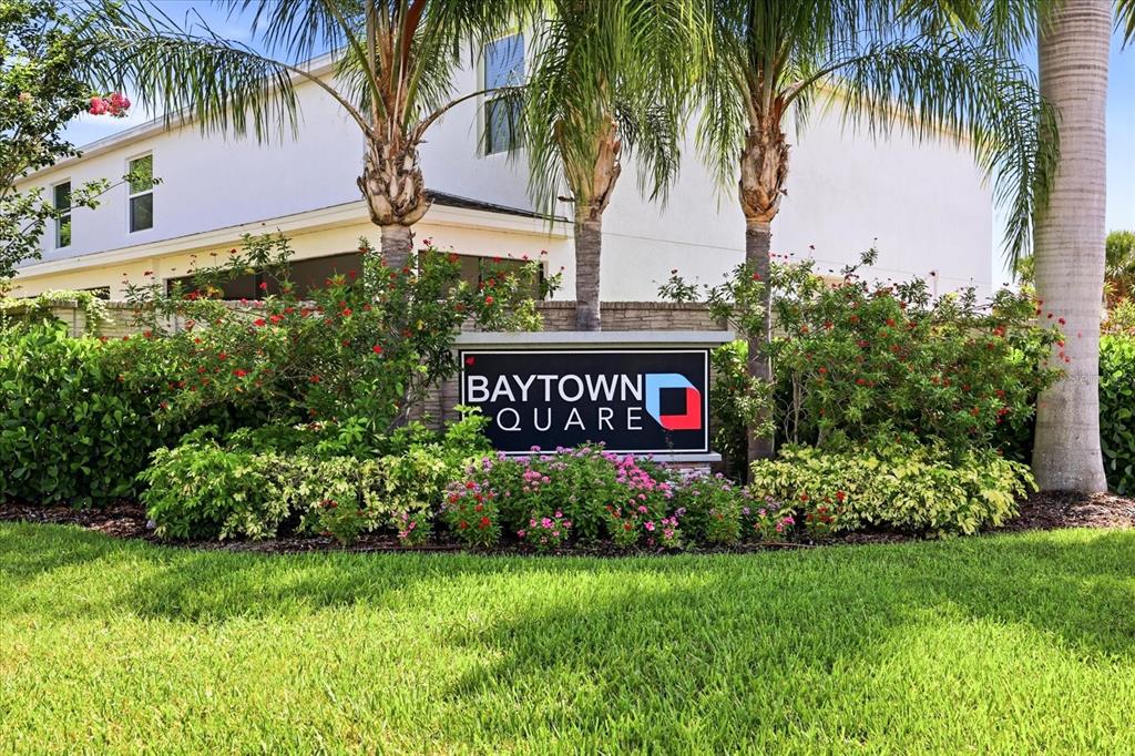 A sign for Baytown Square stands in front of a white building and palm trees — 6453 BAYTOWN DRIVE, SARASOTA, FL