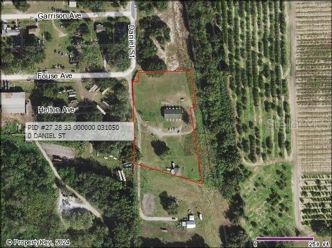 An aerial map view shows a parcel of land with two buildings and surrounding vegetation — 1002 DANIELS STREET, DUNDEE, FL
