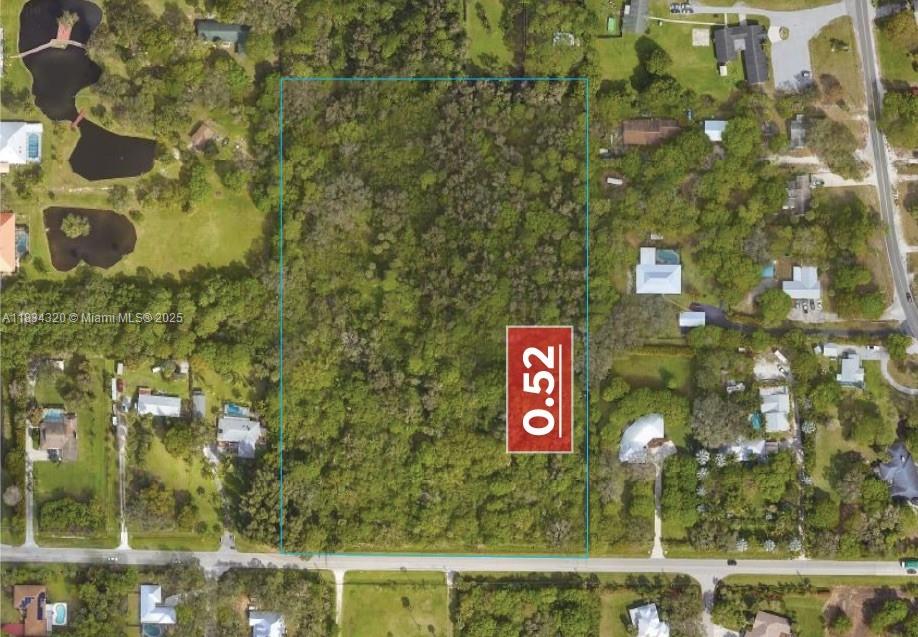 This aerial view shows a rectangular, wooded vacant lot outlined in blue — 2002 Bell Ave, Fort Pierce FL 34982, FORT PIERCE, FL