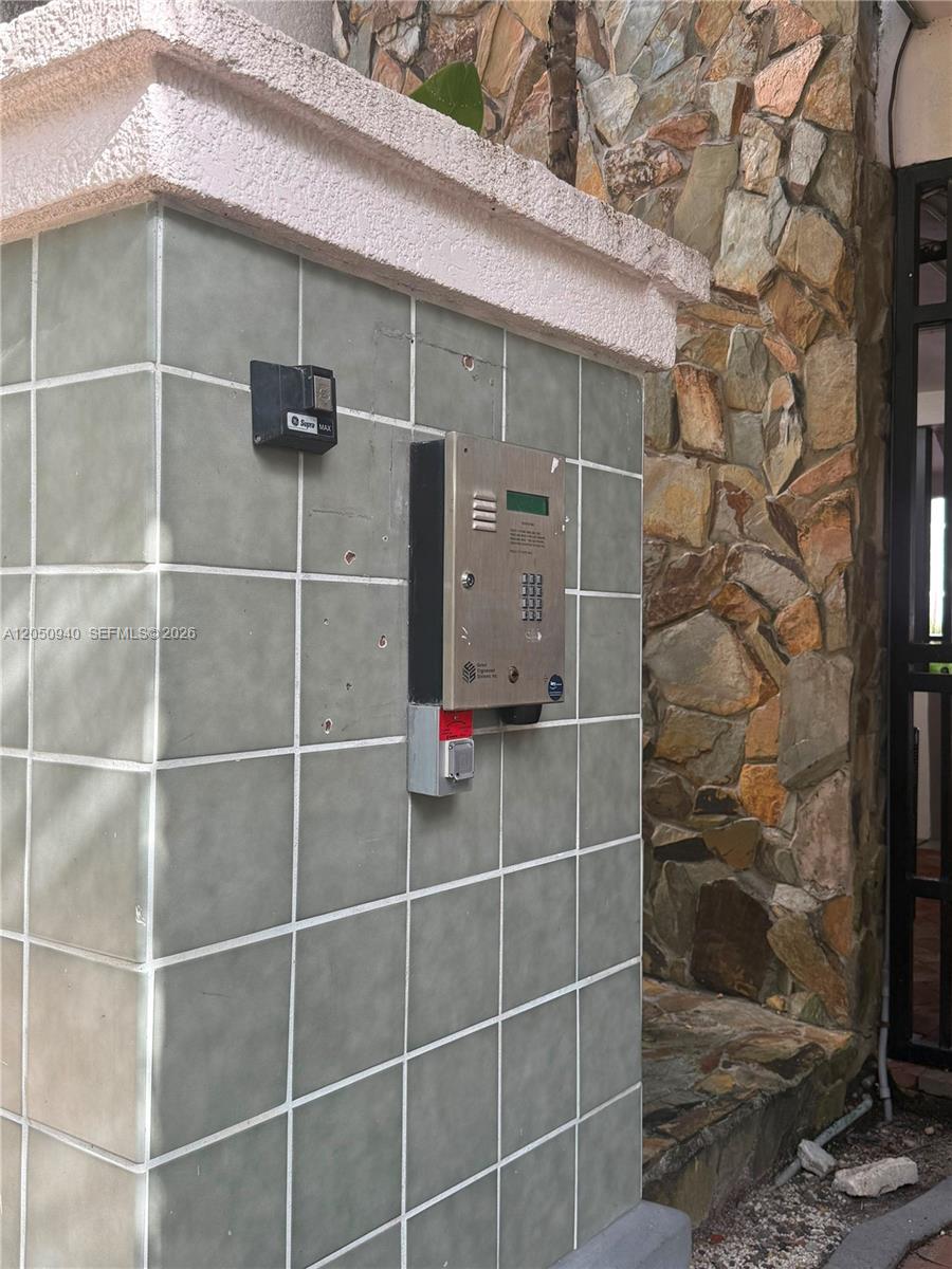 A tiled pillar features an intercom system and a small black lockbox near a gate — 2924 Day Ave # N110, Miami FL 33133, MIAMI, FL