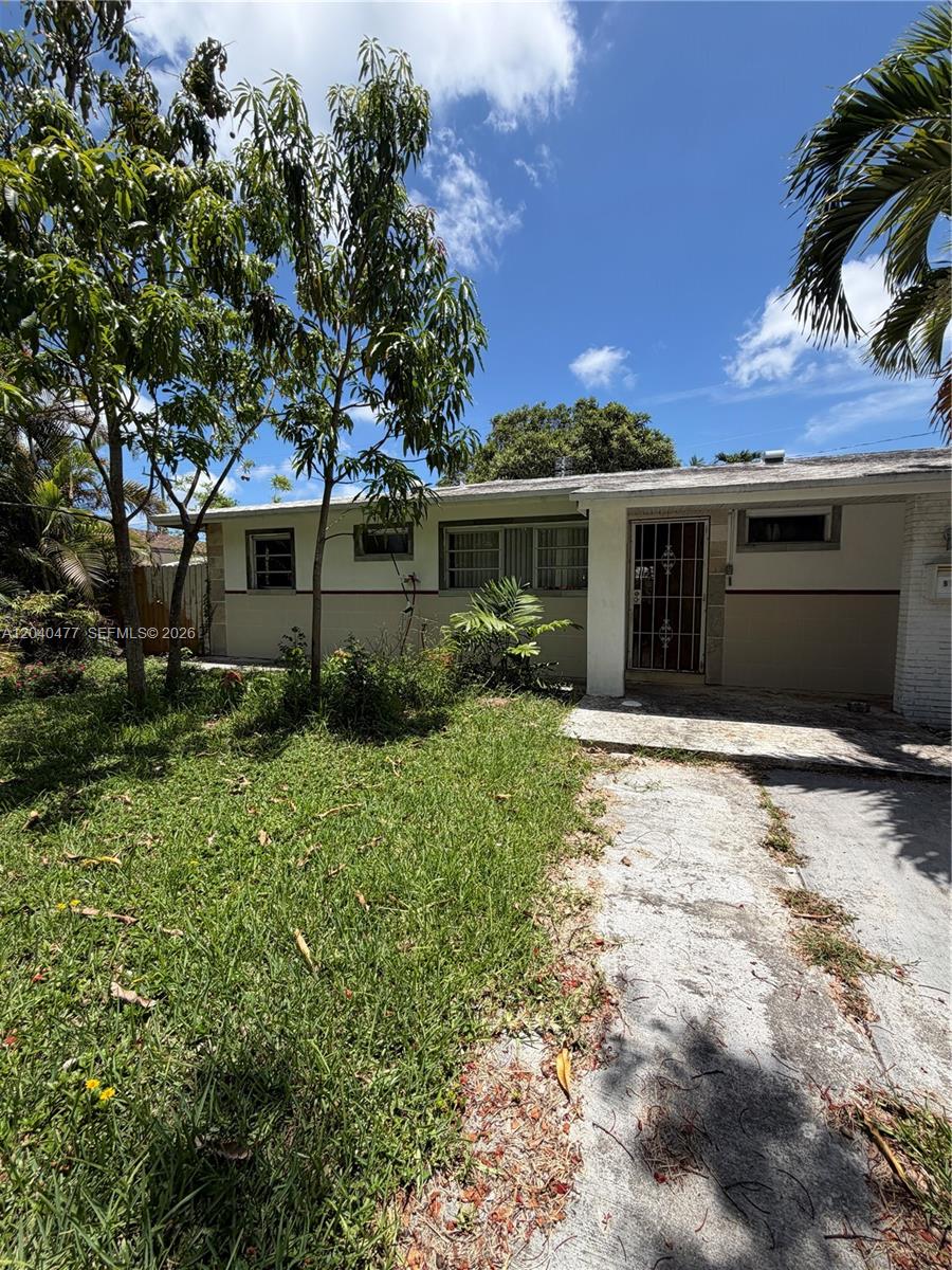 A single-story house with a concrete driveway, a front porch, and a grassy yard — 9110 SW 44th St, Miami FL 33165, MIAMI, FL