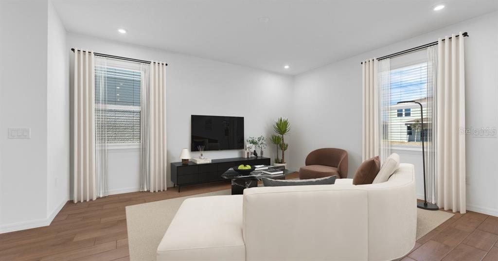 This is a digital rendering of a living room with a white sofa and television — 757 CASTLEFORD AVENUE NE, PALM BAY, FL