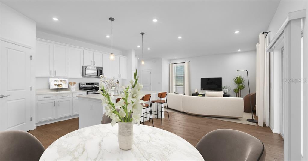 This is a digital rendering of an open-concept kitchen and living room with white cabinetry — 757 CASTLEFORD AVENUE NE, PALM BAY, FL