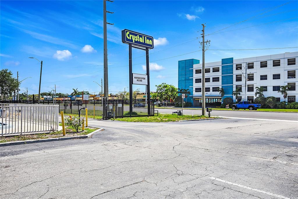 A Crystal Inn sign stands near a parking lot in front of a multi-story building — 4600 34TH STREET S, ST PETERSBURG, FL