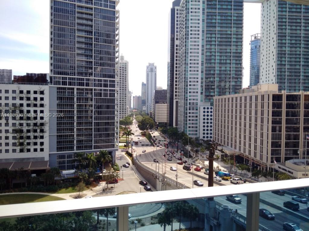 An elevated view of a city street lined with tall skyscrapers and traffic — 200 Biscayne Boulevard Way # 906, Miami FL 33131, MIAMI, FL