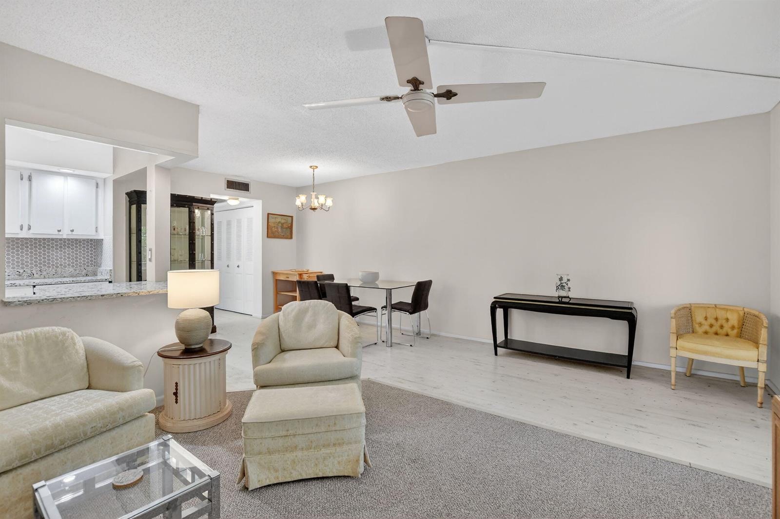 A living and dining area features a ceiling fan, neutral walls, and mixed flooring — 4038 Durham B, Deerfield Beach FL 33442, DEERFIELD BEACH, FL