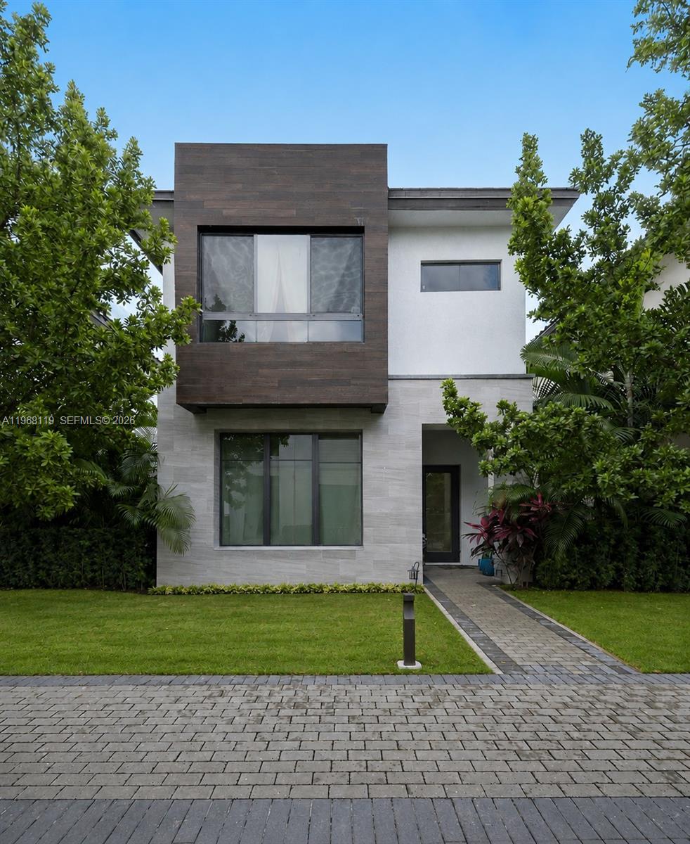A two-story modern house features a stone facade, dark wood paneling, and a paved walkway — 4454 NW 80th Ave, Doral FL 33166, DORAL, FL