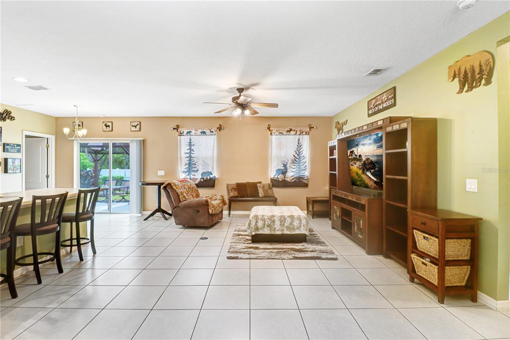 A single-story house with a beige exterior, a two-car garage, and a front walkway — 12152 LANDFAIR STREET, SPRING HILL, FL