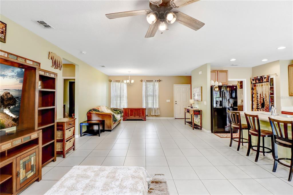 A single-story house with a beige stucco exterior, a two-car garage, and a front lawn — 12152 LANDFAIR STREET, SPRING HILL, FL