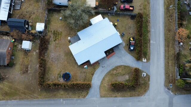 An aerial view shows a house with a metal roof, a driveway, and a fenced yard — 4472 SE Alden Avenue, Stuart FL 34997, STUART, FL