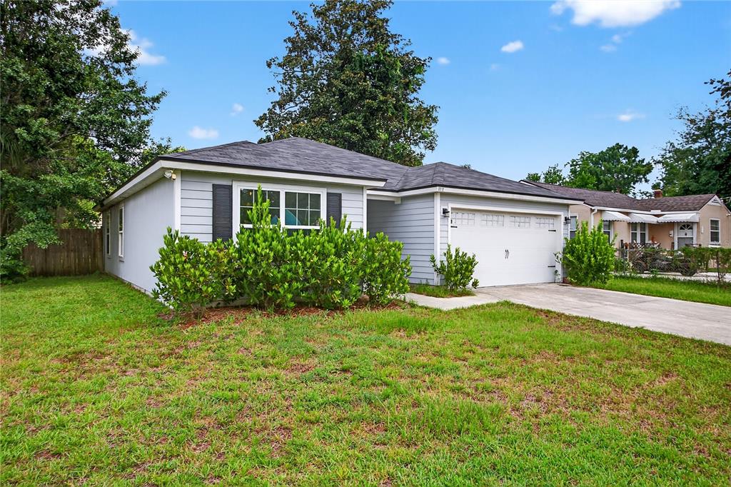 A single-story house with light gray siding, a white garage door, and a front lawn — 5315 COLONIAL AVENUE, JACKSONVILLE, FL