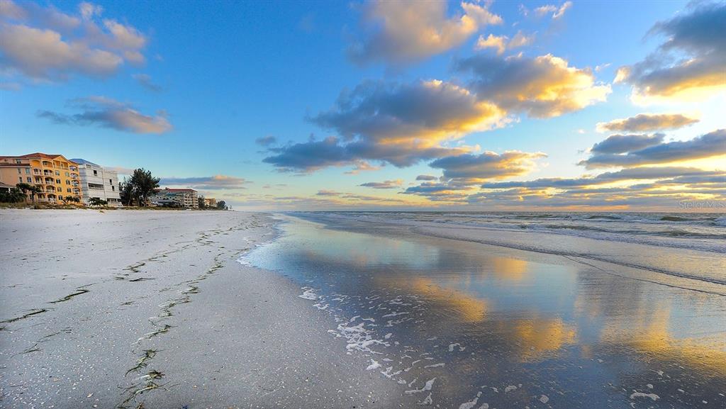 An aerial view of a multi-story beachfront condominium complex with a parking lot and pool — 18650 GULF BOULEVARD UNIT 203, INDIAN SHORES, FL