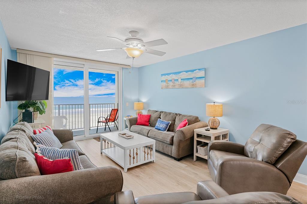 The exterior of a multi-story apartment building features a covered entrance with the number 18650 — 18650 GULF BOULEVARD UNIT 203, INDIAN SHORES, FL