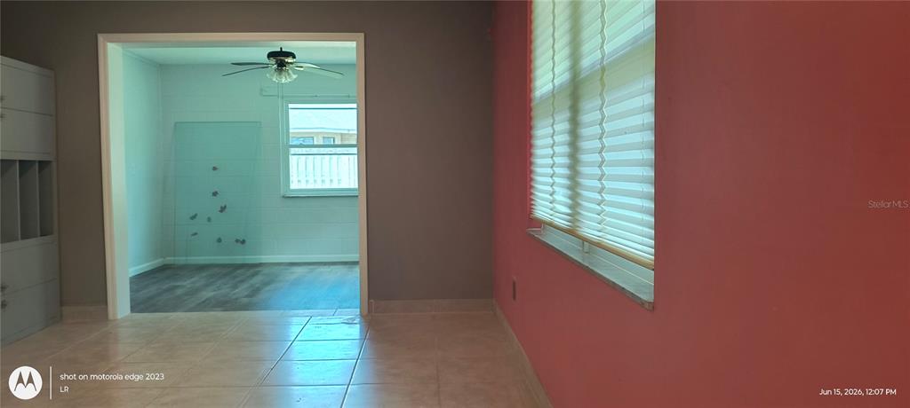 A room with tiled floors and a red wall leads into a second room — 5920 NW 62ND PLACE, OCALA, FL