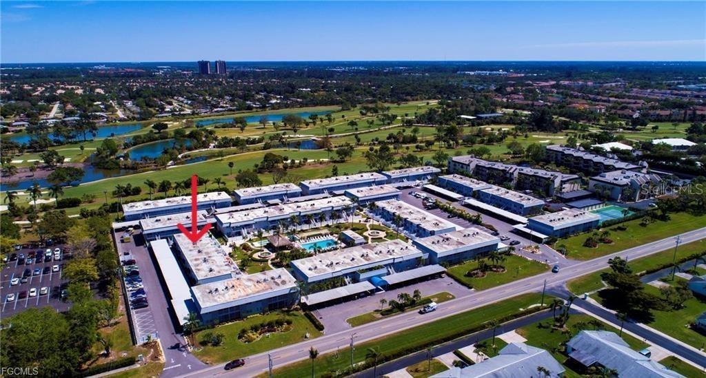 An aerial view shows a multi-story apartment complex with a red arrow pointing to a unit — 6777 WINKLER ROAD UNIT 134, FORT MYERS, FL