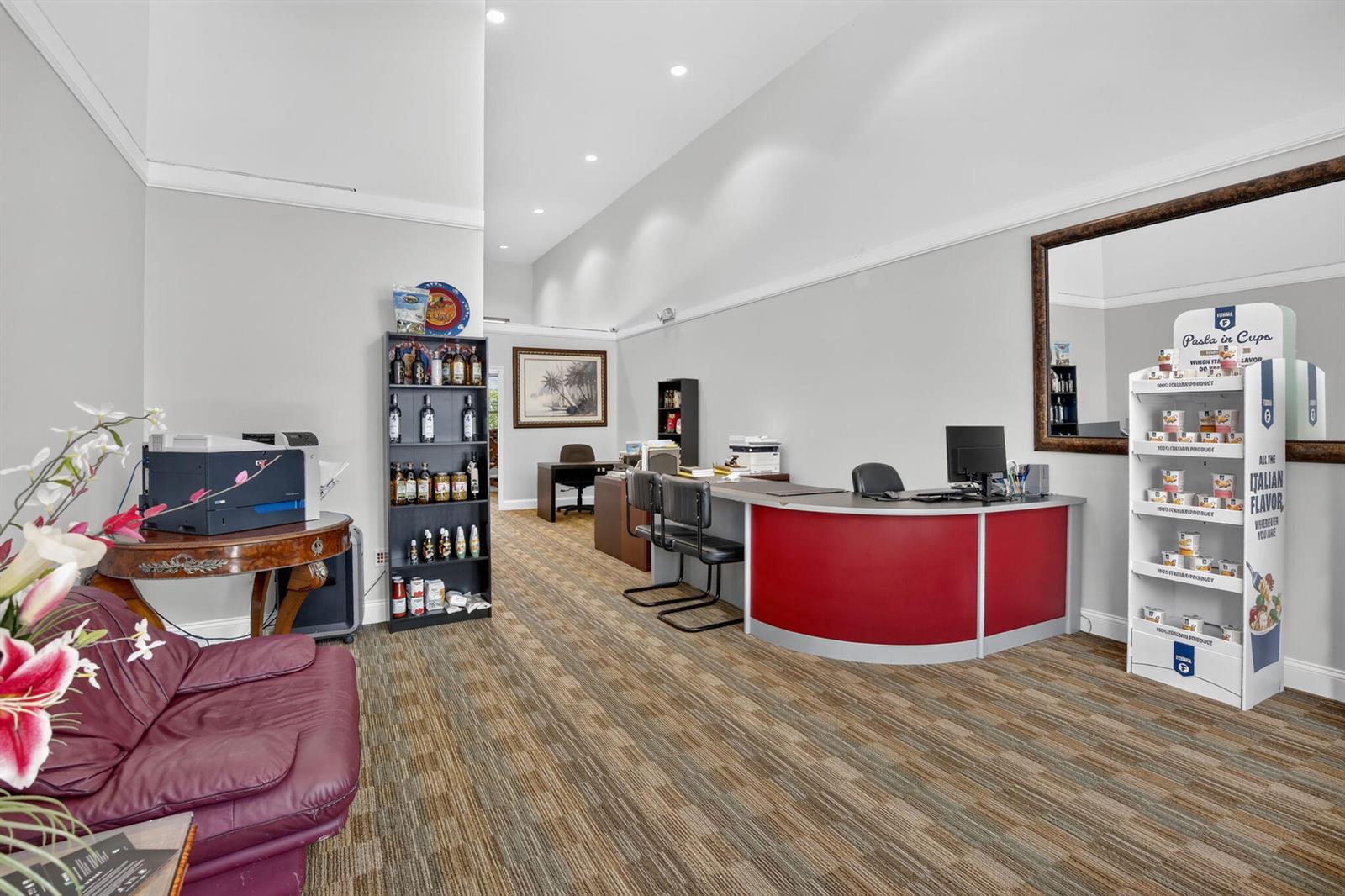 An office space features a red reception desk, a shelving unit, and a purple sofa — 5200 S University Drive # 103a, Davie FL 33328, DAVIE, FL