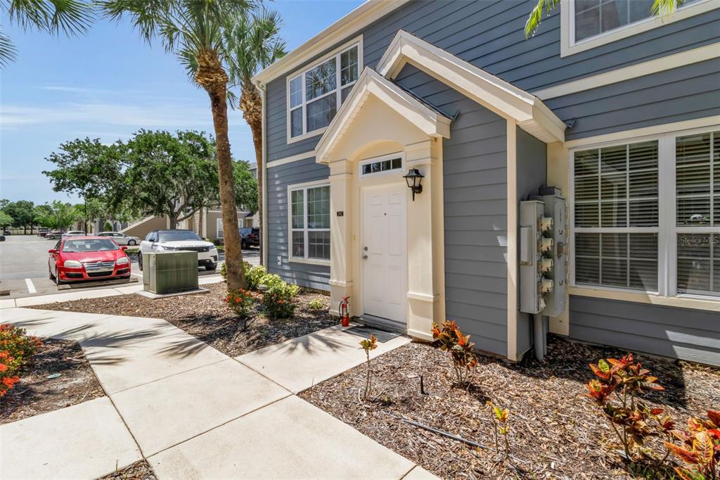 A blue two-story building with a white front door and a concrete walkway — 5541 ROSEHILL ROAD UNIT 202, SARASOTA, FL
