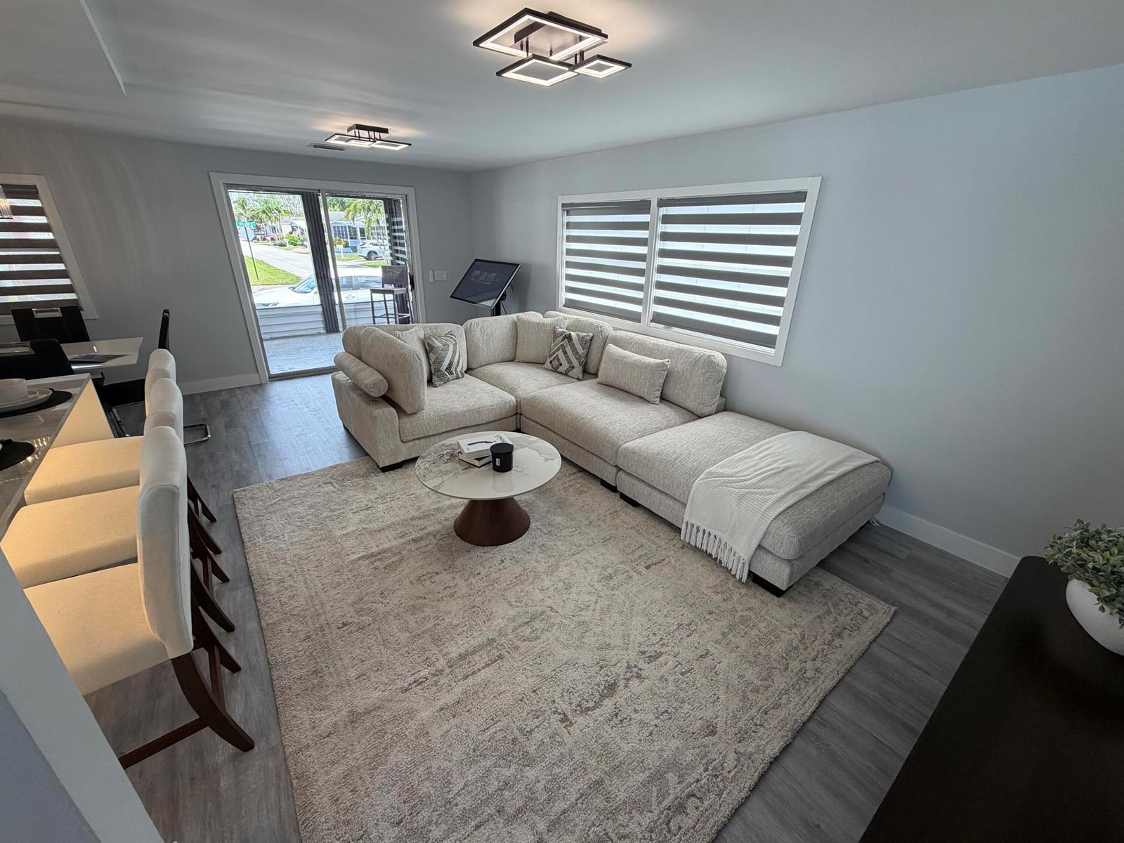 A living room features a sectional sofa, a round coffee table, and a breakfast bar — 6600 NW 29th Court, Margate FL 33063, MARGATE, FL