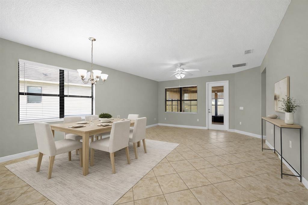 A dining room with tile floors, a wooden table, four chairs, and a chandelier — 507 PRESIDO PARK PLACE, KISSIMMEE, FL