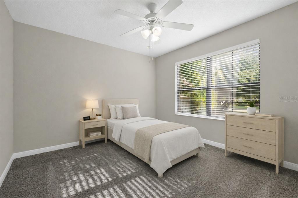 A bedroom with gray carpet, a single bed, a nightstand, and a dresser — 507 PRESIDO PARK PLACE, KISSIMMEE, FL