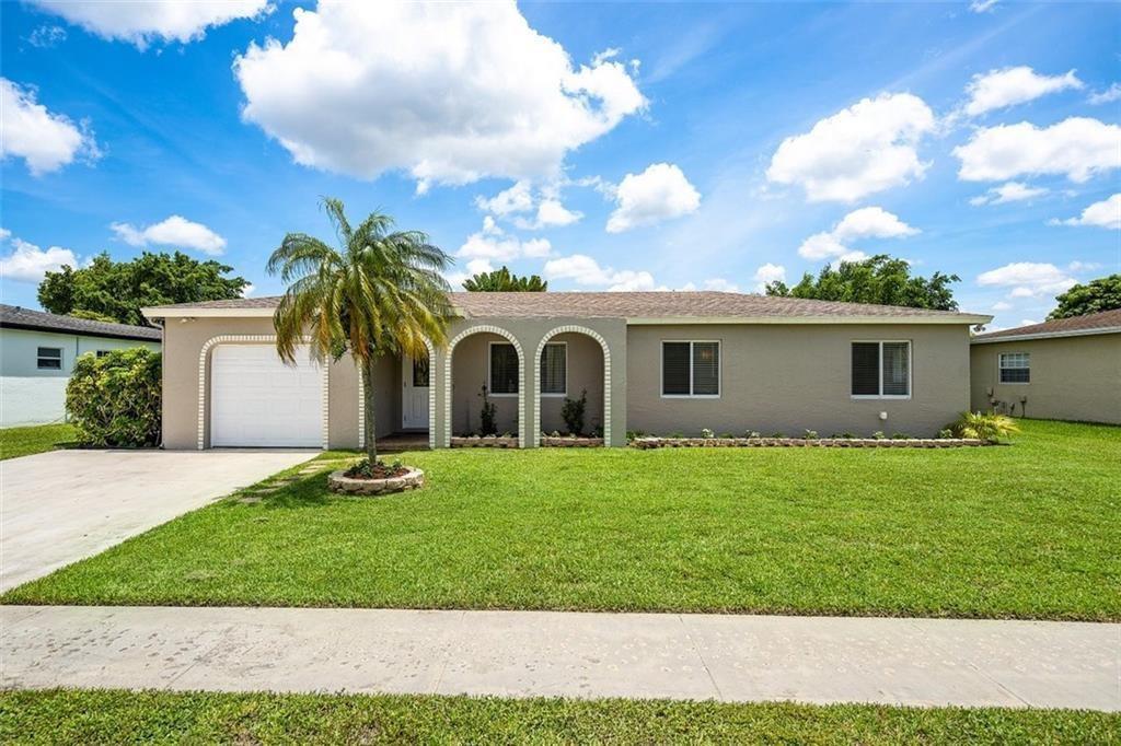 A single-story house with a tan exterior, arched entryway, and a palm tree in front — 10884 Gantry Street, Boca Raton FL 33428, BOCA RATON, FL