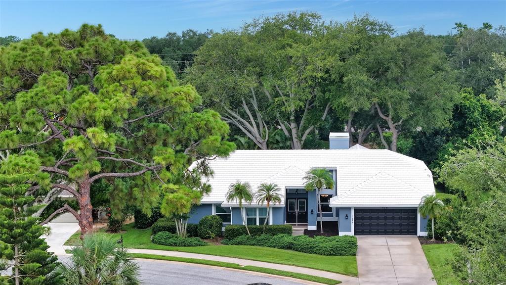 An aerial view of a blue house with a white roof and a two-car garage — 4391 MAPLEWOOD LANE, SARASOTA, FL