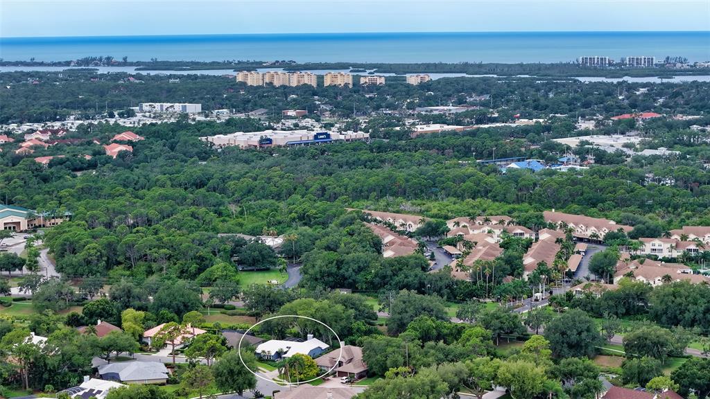 An aerial view shows a residential neighborhood with a circled single-story house surrounded by trees — 4391 MAPLEWOOD LANE, SARASOTA, FL