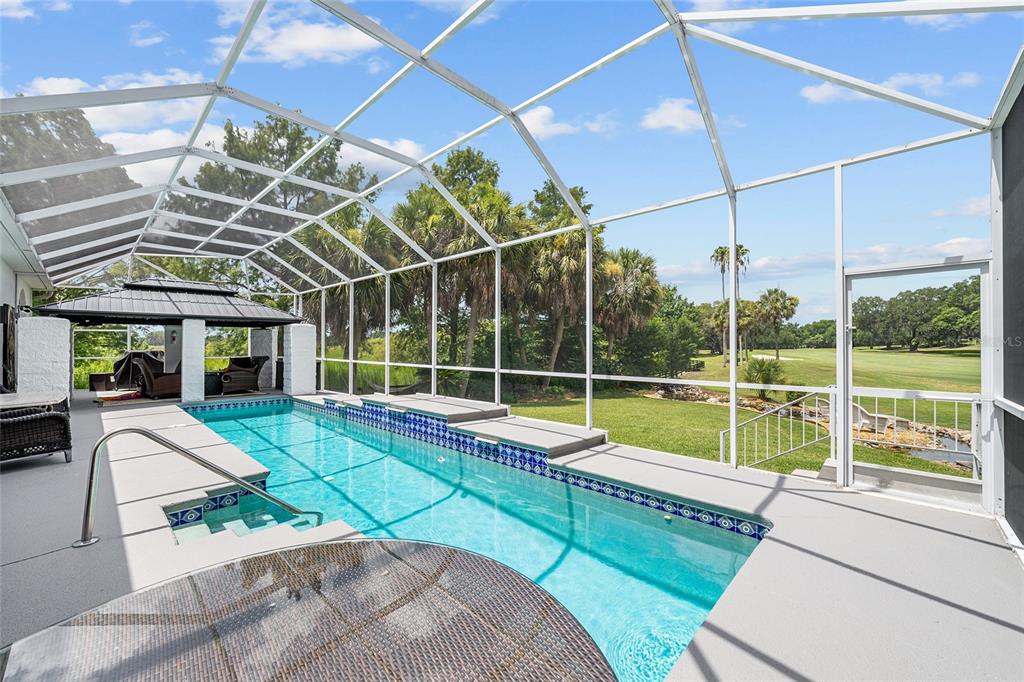 An aerial view shows a white single-story house with a dark roof and two-car garage — 714 CIMARRON AVENUE, THE VILLAGES, FL