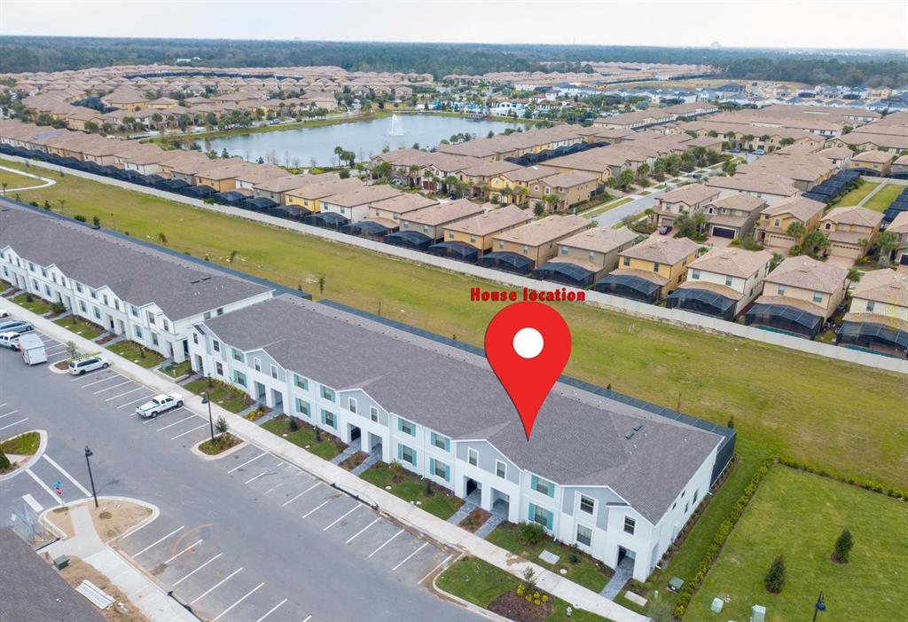 An aerial view shows a row of townhouses with a red location pin marker — 8944 SYDNEY AVENUE, KISSIMMEE, FL