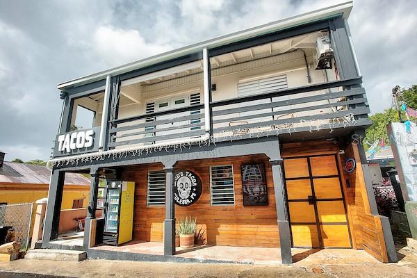 A two-story building with a wooden facade, a taco sign, and a second-floor balcony — 23 PEDRO MARQUEZ STREET, CULEBRA, PR