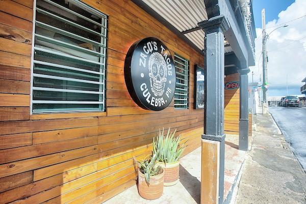 The exterior of a wooden building features a round skull sign for Zaco's Tacos — 23 PEDRO MARQUEZ STREET, CULEBRA, PR