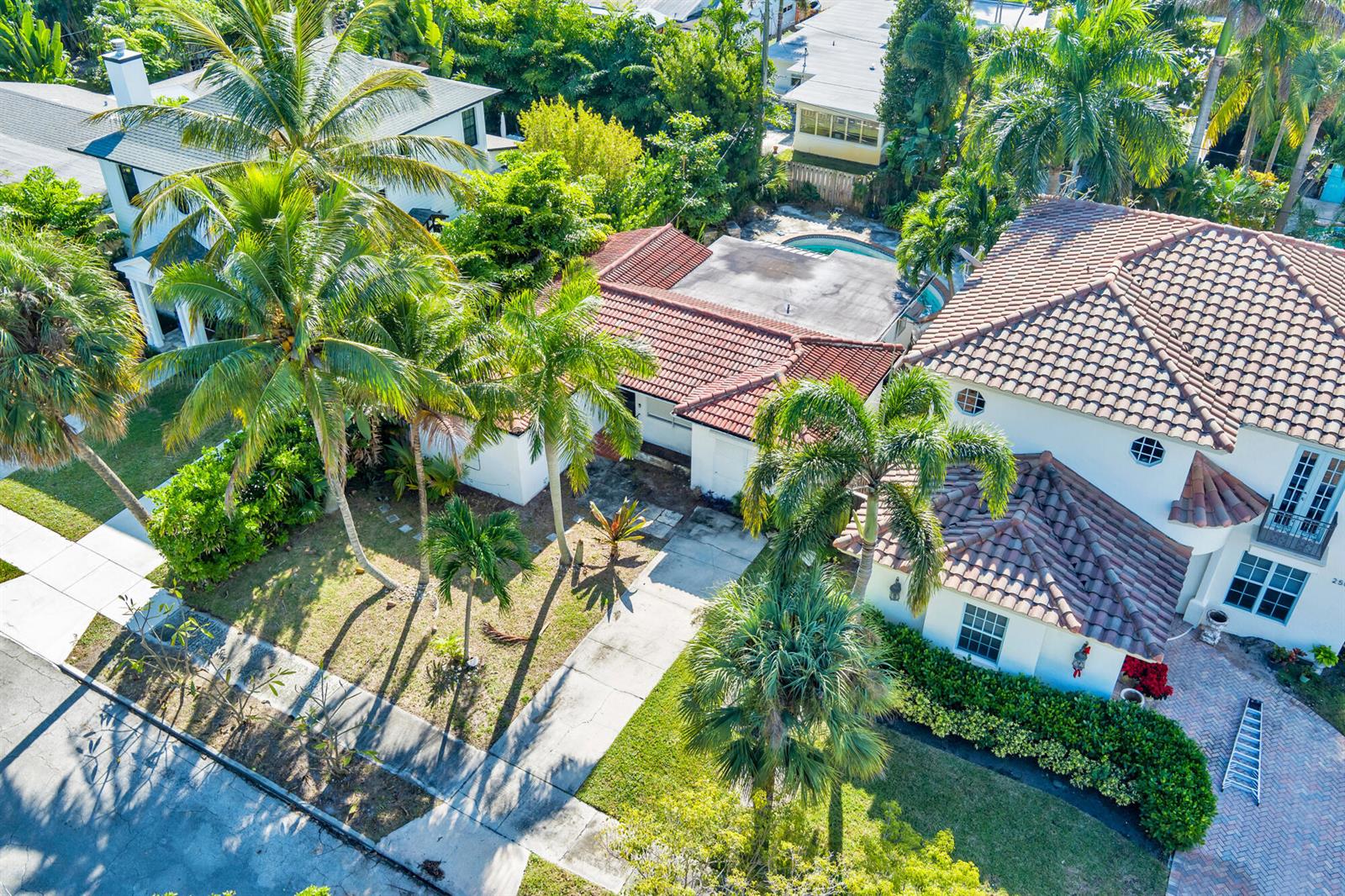 An aerial view of a two-story house with a tiled roof, palm trees, and pool — 244 31st Street, West Palm Beach FL 33407, WEST PALM BEACH, FL