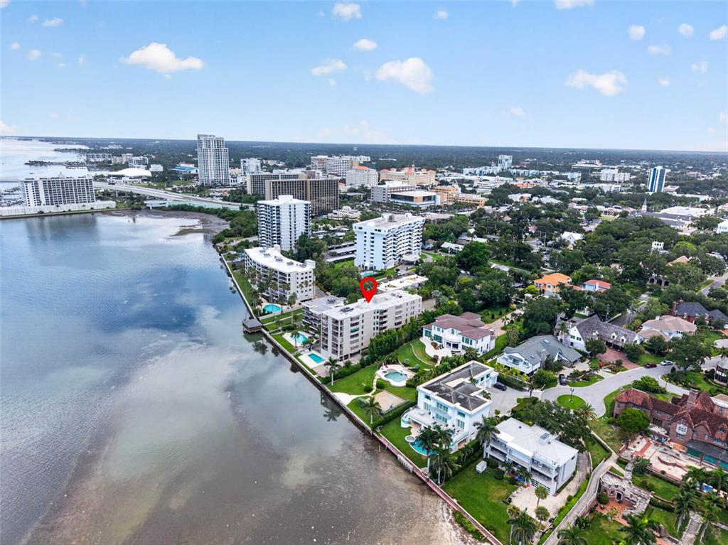 An aerial view shows a waterfront apartment building marked with a red pin — 602 LIME AVENUE UNIT 101, CLEARWATER, FL