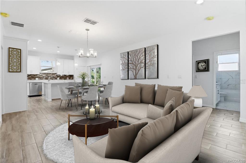 This is a digital rendering of an open-concept living room and kitchen with neutral furniture — 822 POPLAR STREET, INVERNESS, FL