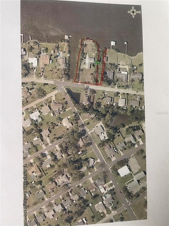 This aerial map shows a residential property outlined in red along a waterfront — 2616 SUNSET DRIVE, NEW SMYRNA BEACH, FL